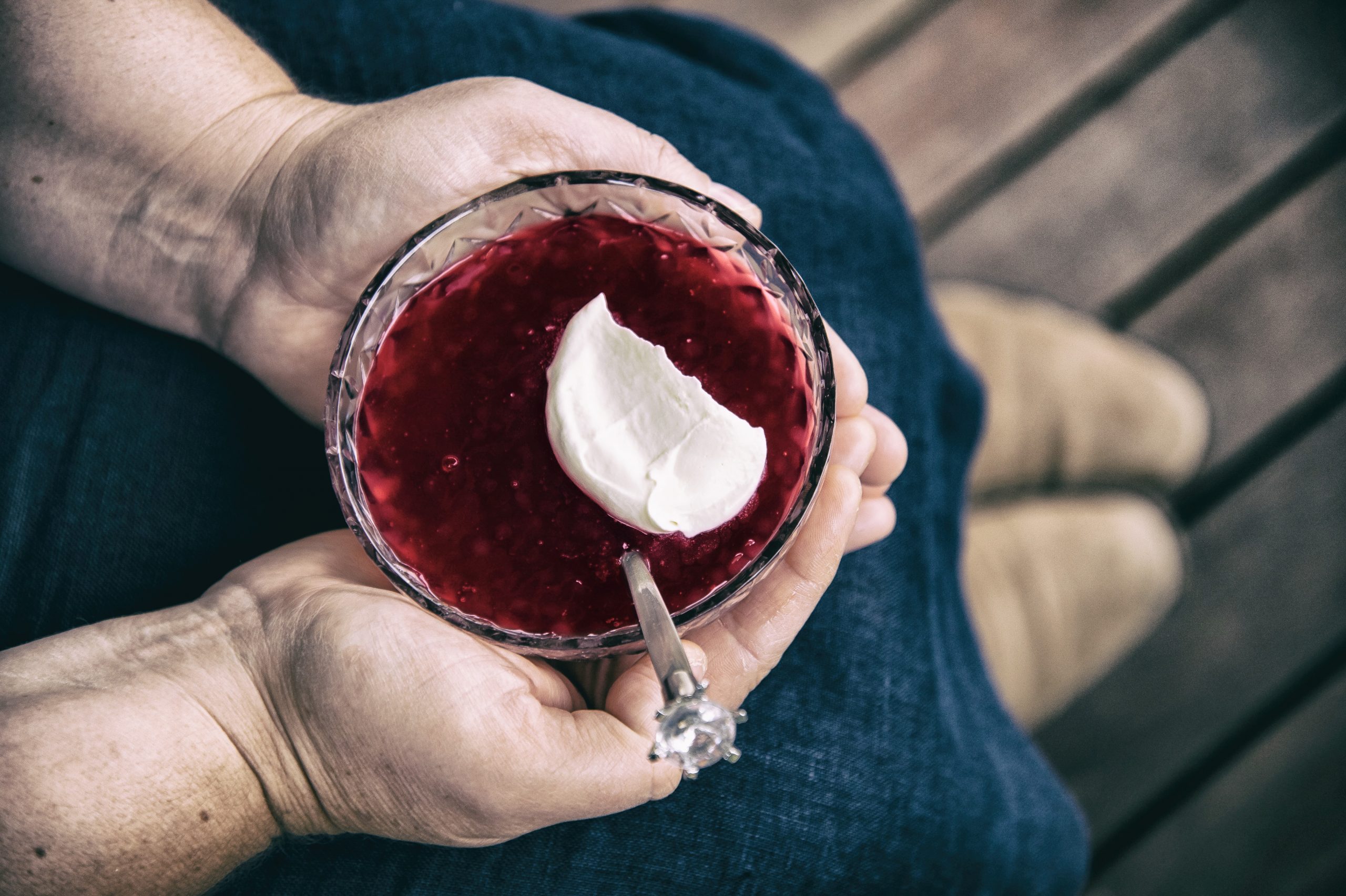 A bowl of Rote Grütze with a dollop of fresh cream